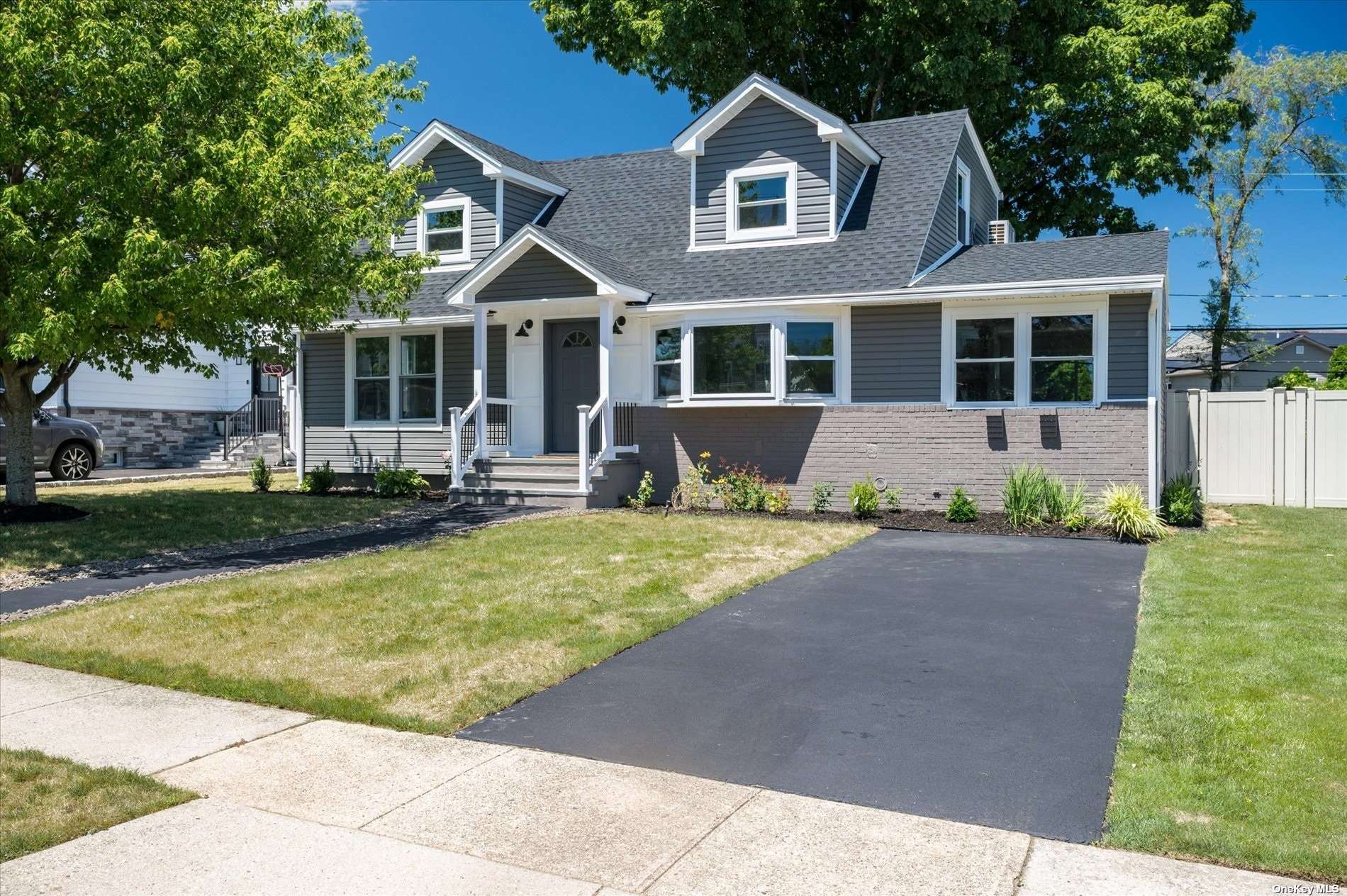 a front view of a house with a yard and porch