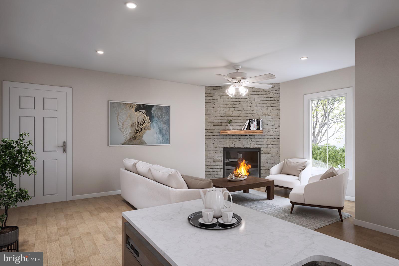 a living room with furniture a fireplace and a large window