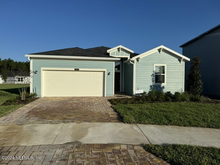 a front view of a house with a yard and garage