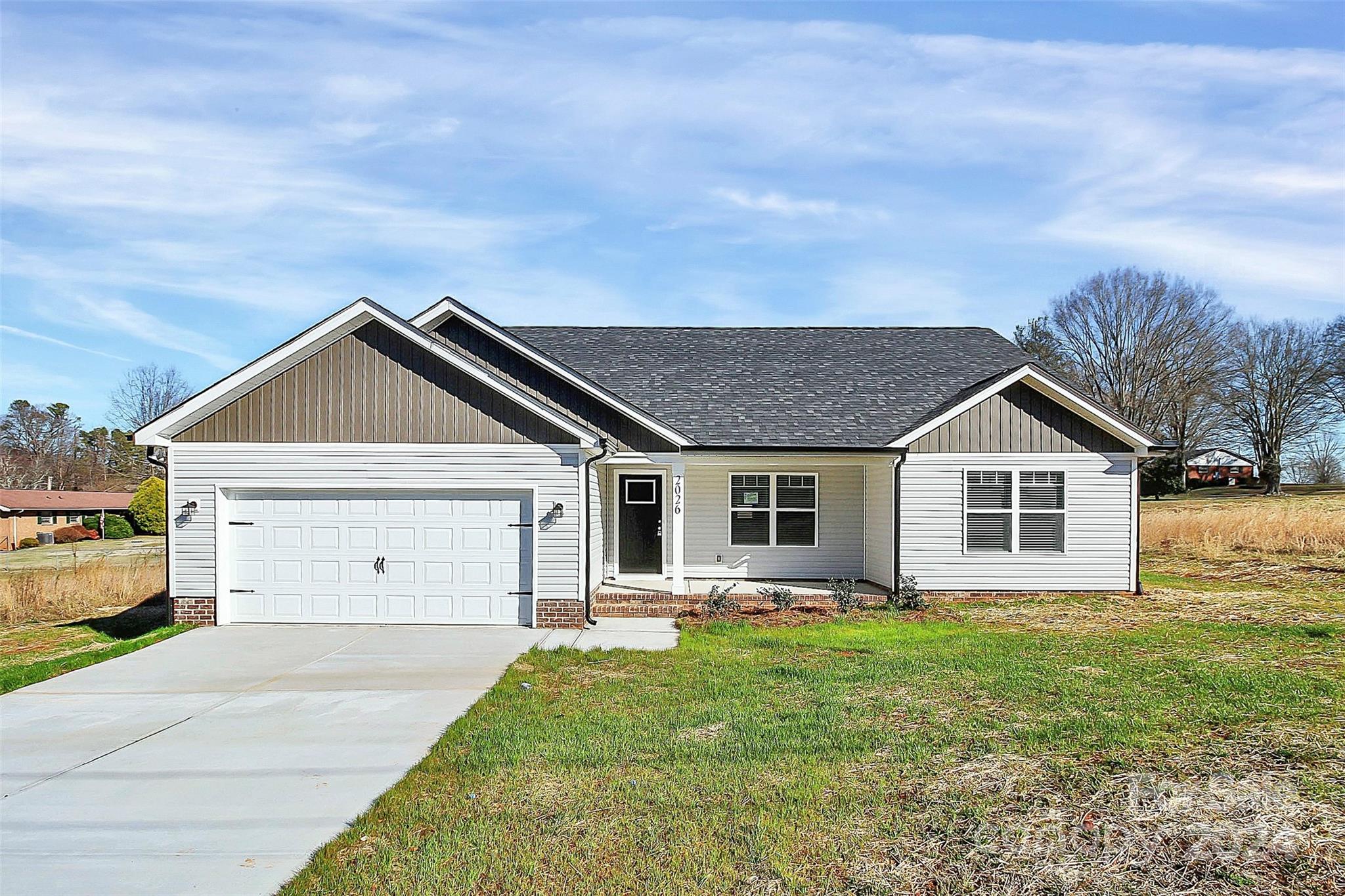 a front view of house with yard and green space