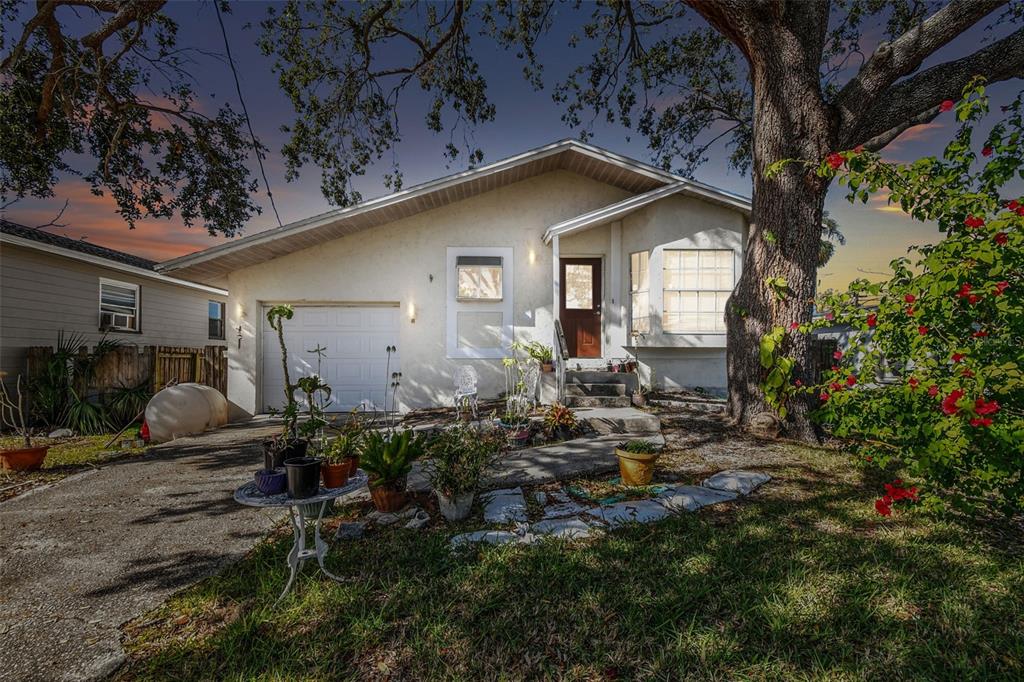 a backyard of a house with table and chairs