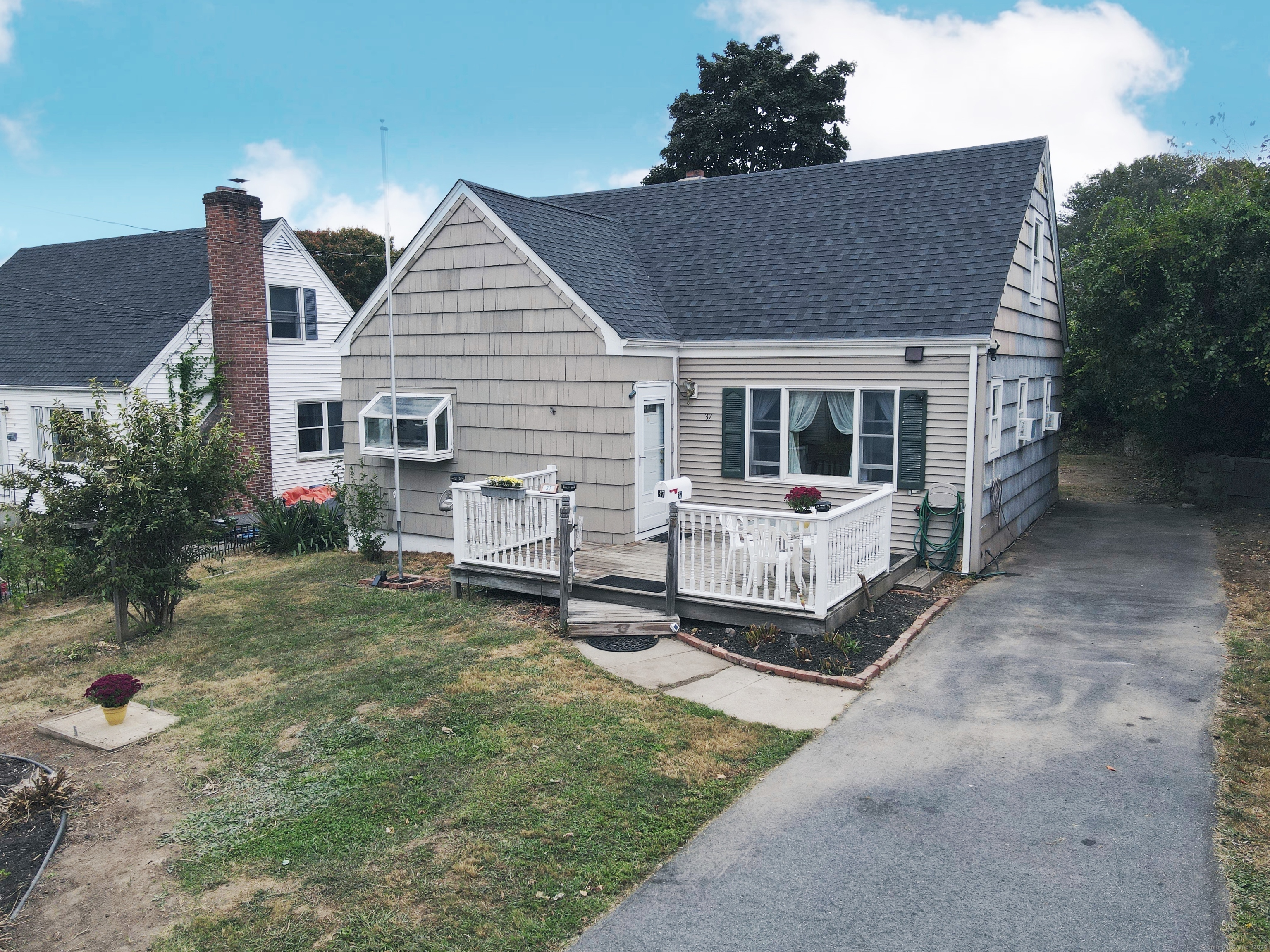 a view of a house with a yard siting area and garden