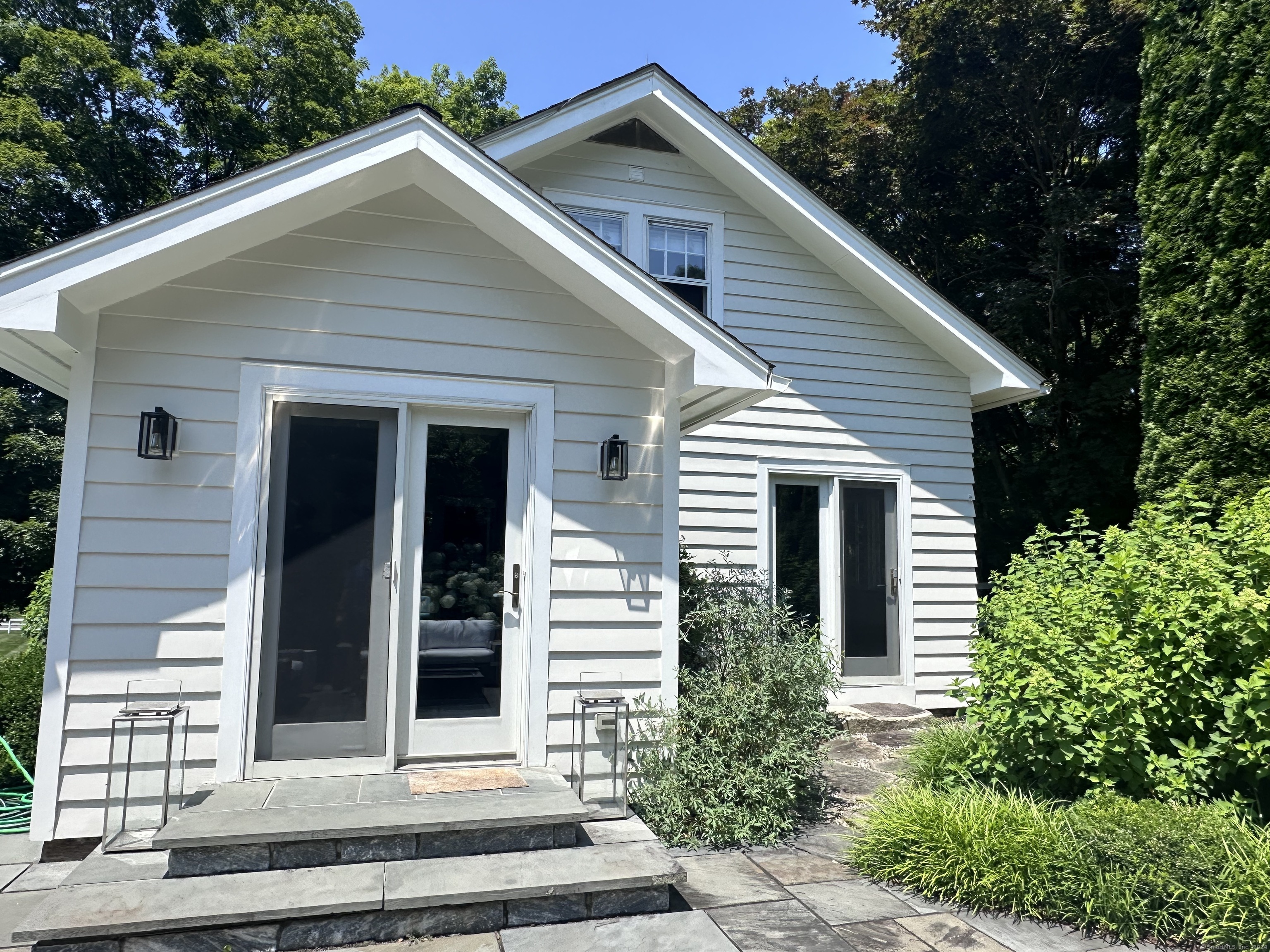 a front view of a house with a garden