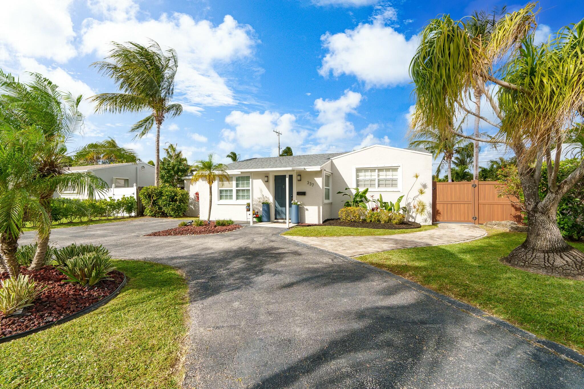 a front view of a house with a yard and fountain