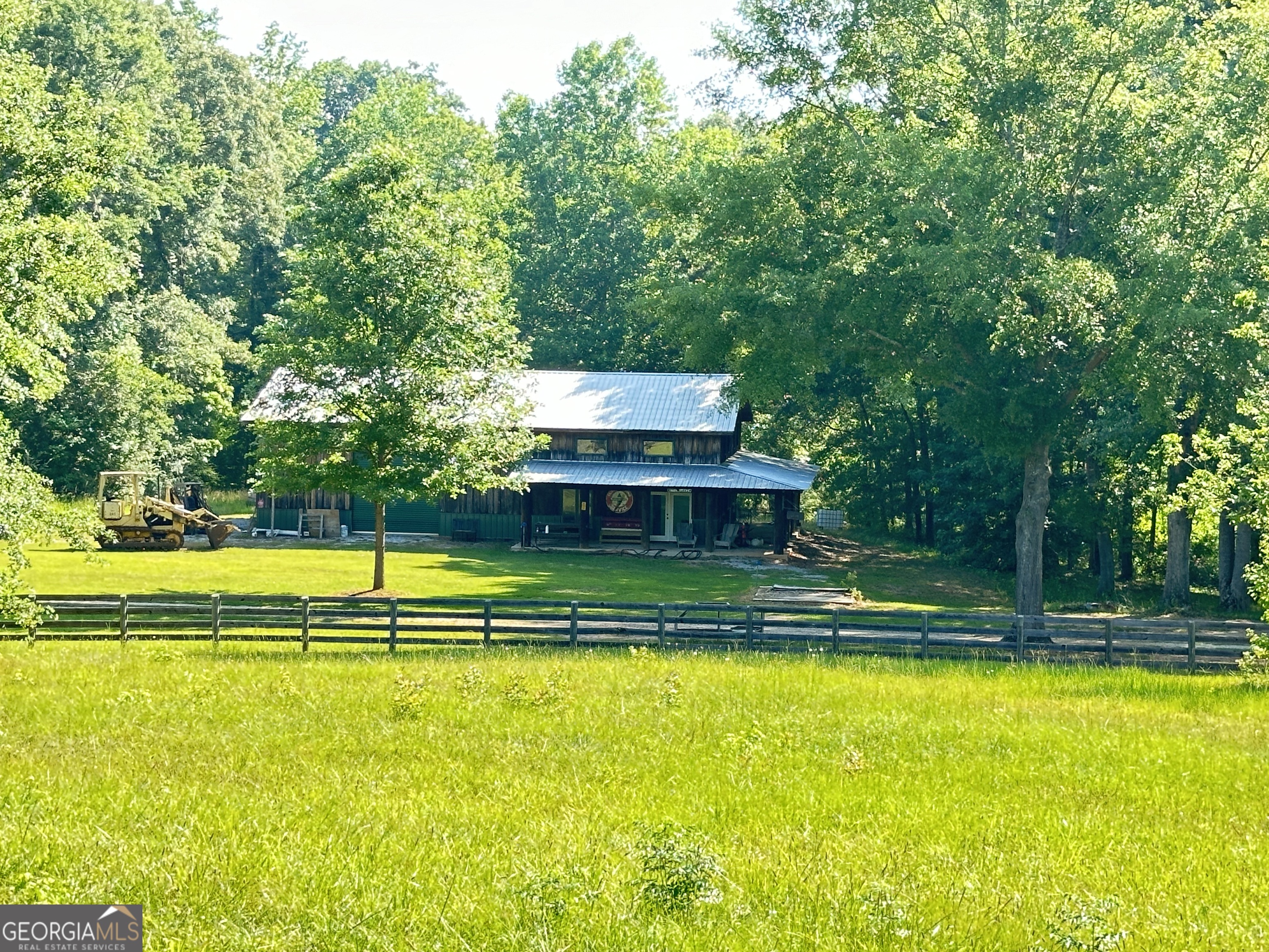 a view of a swimming pool with lawn chairs and plants