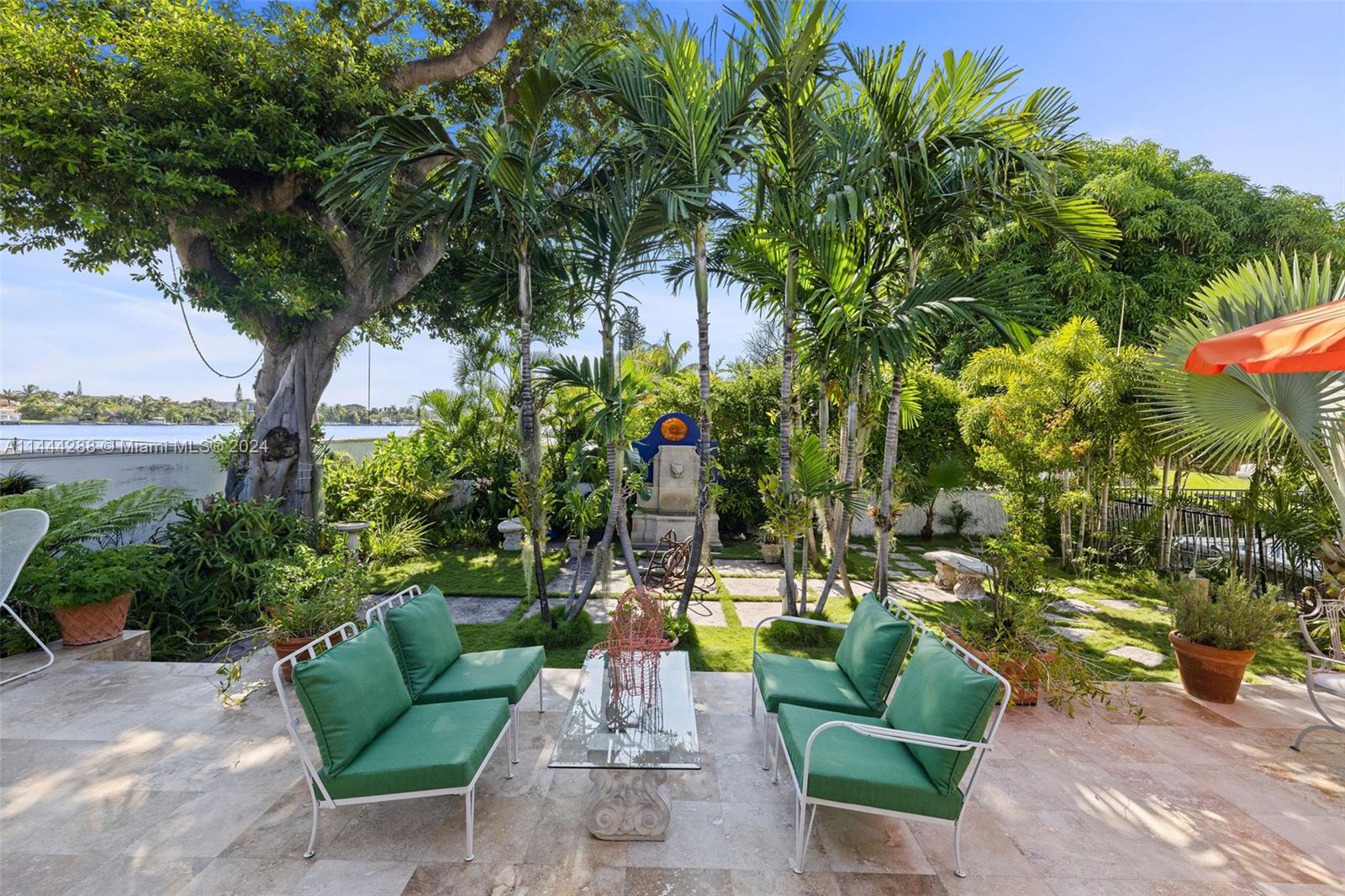 a view of a swimming pool with couches and lounge chairs