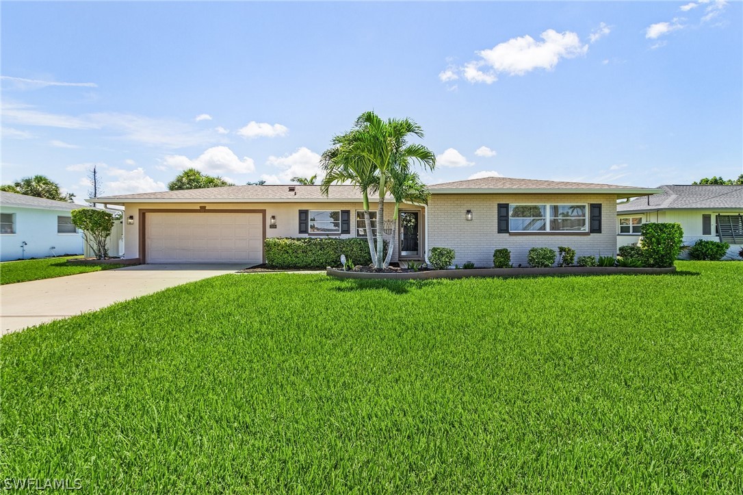 a front view of house with yard and green space