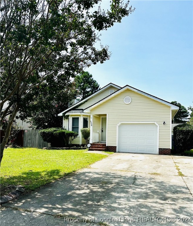 a view of a house with a big yard and large trees