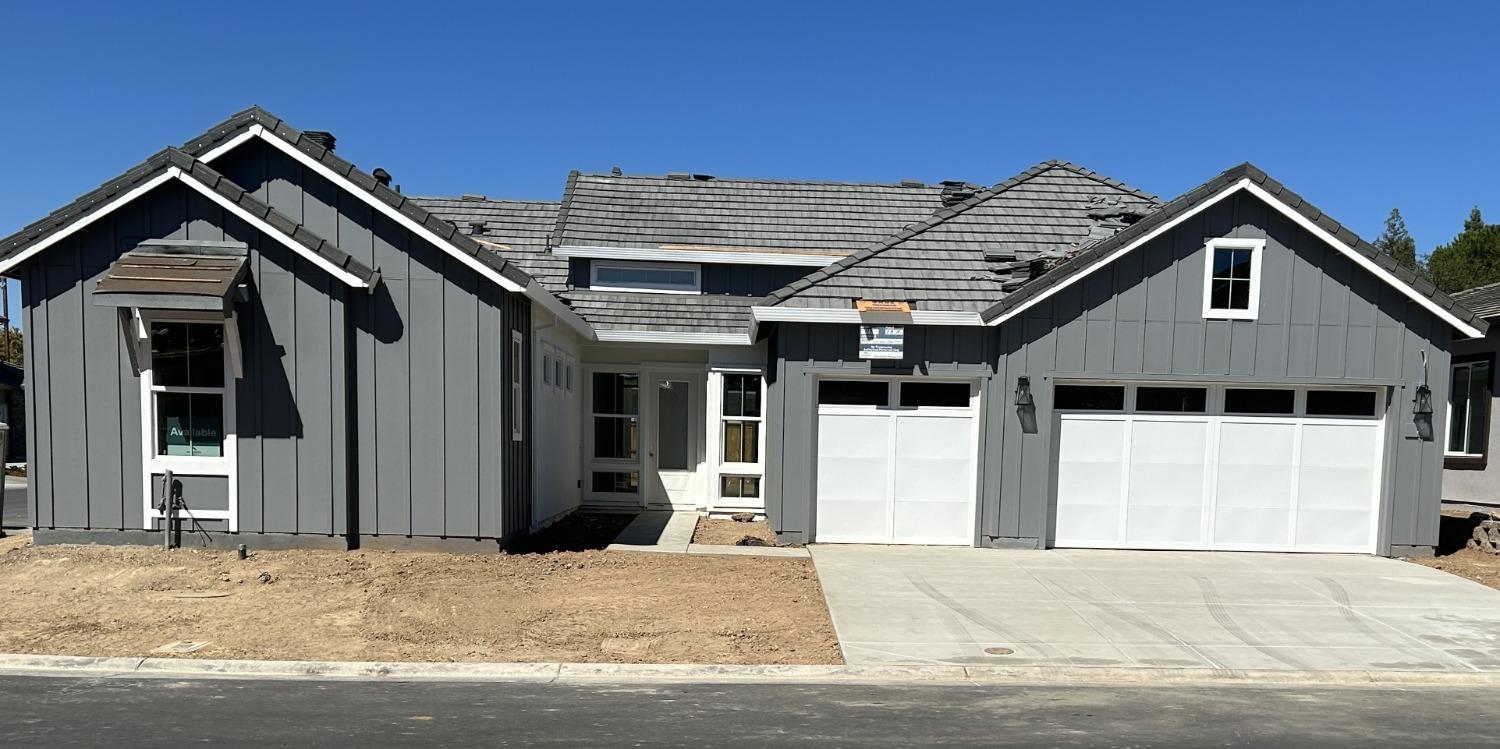 front view of a house with a wooden fence