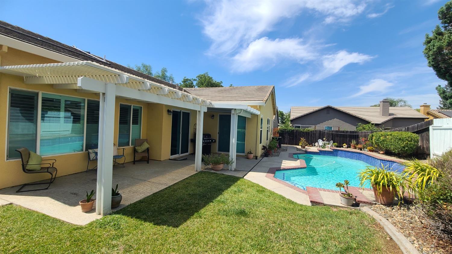 a view of a house with swimming pool and porch