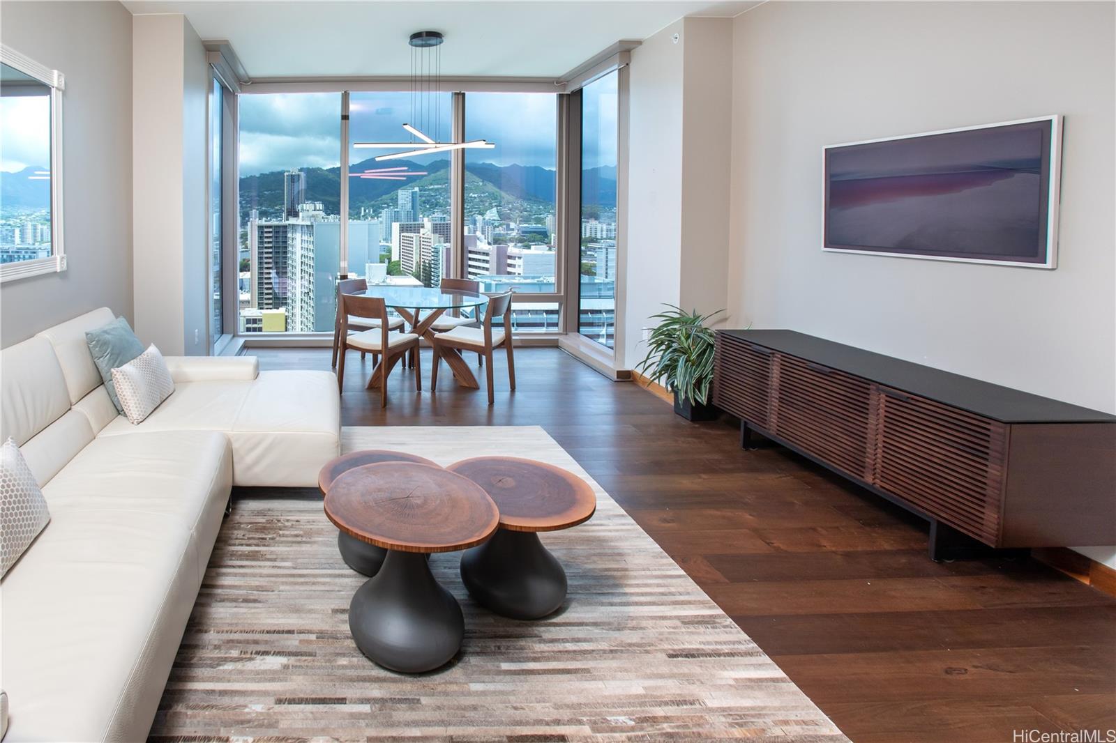 a living room with furniture a rug and a large window