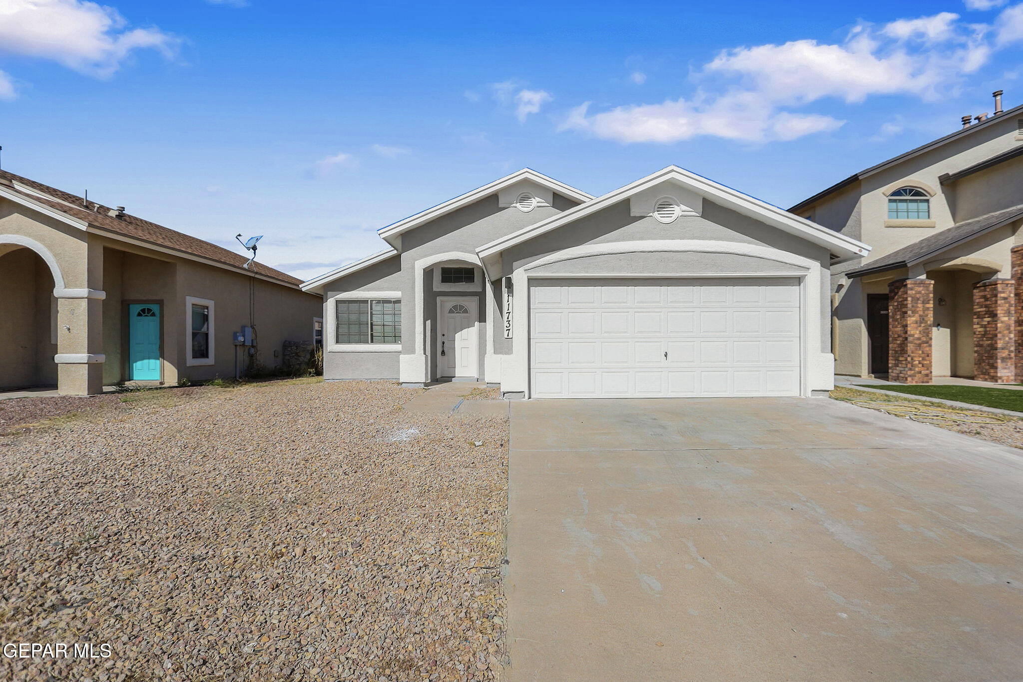 a view of a house with a yard and garage