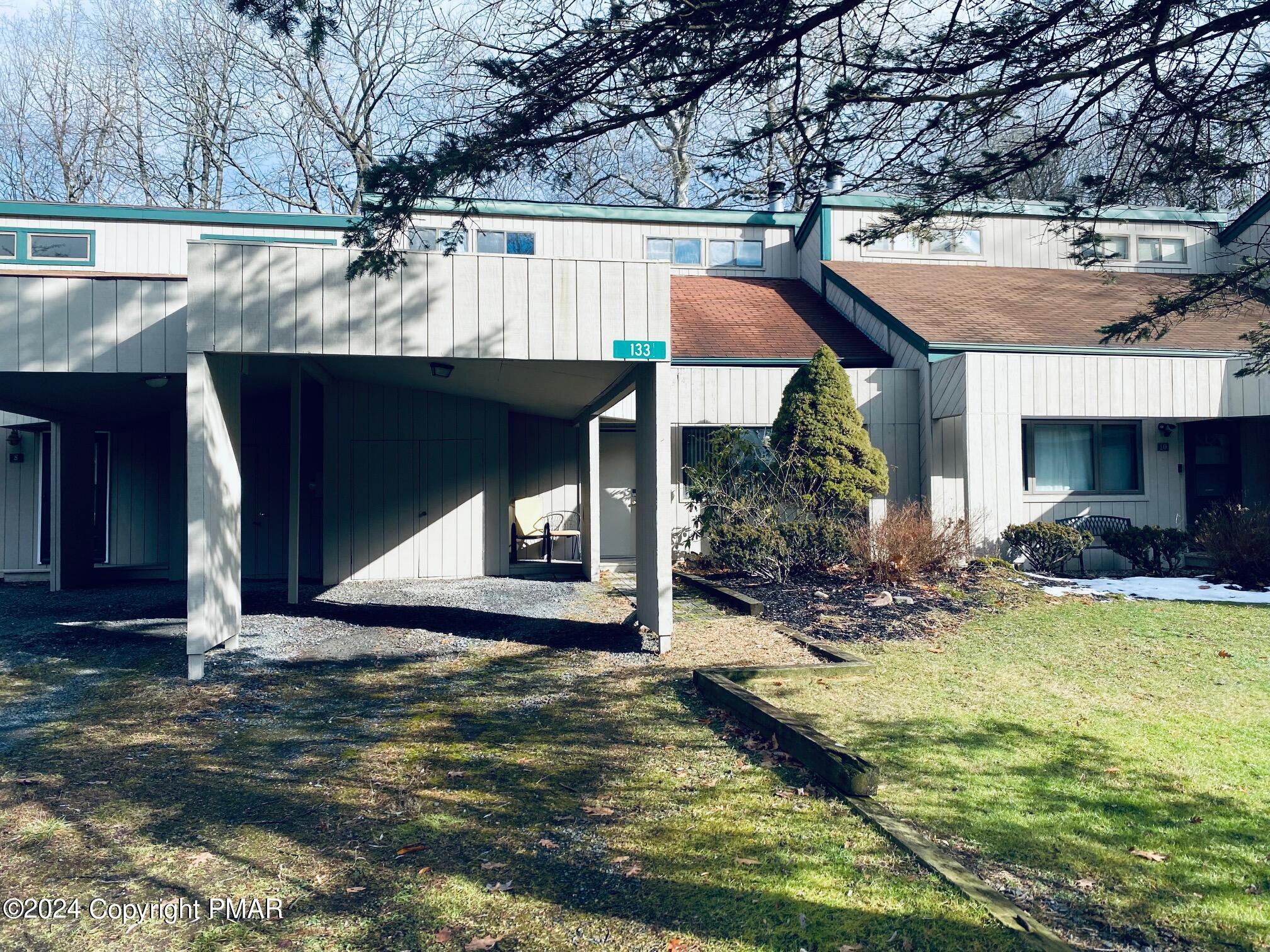 a view of a house with pool and sitting area