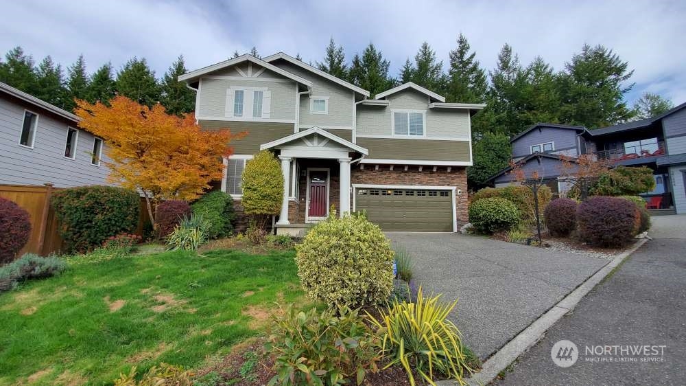 a front view of a house with a garden and plants