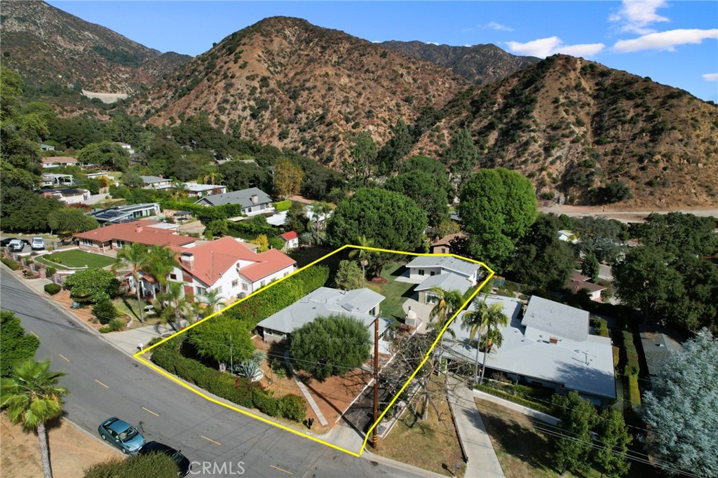 an aerial view of a house with a mountain