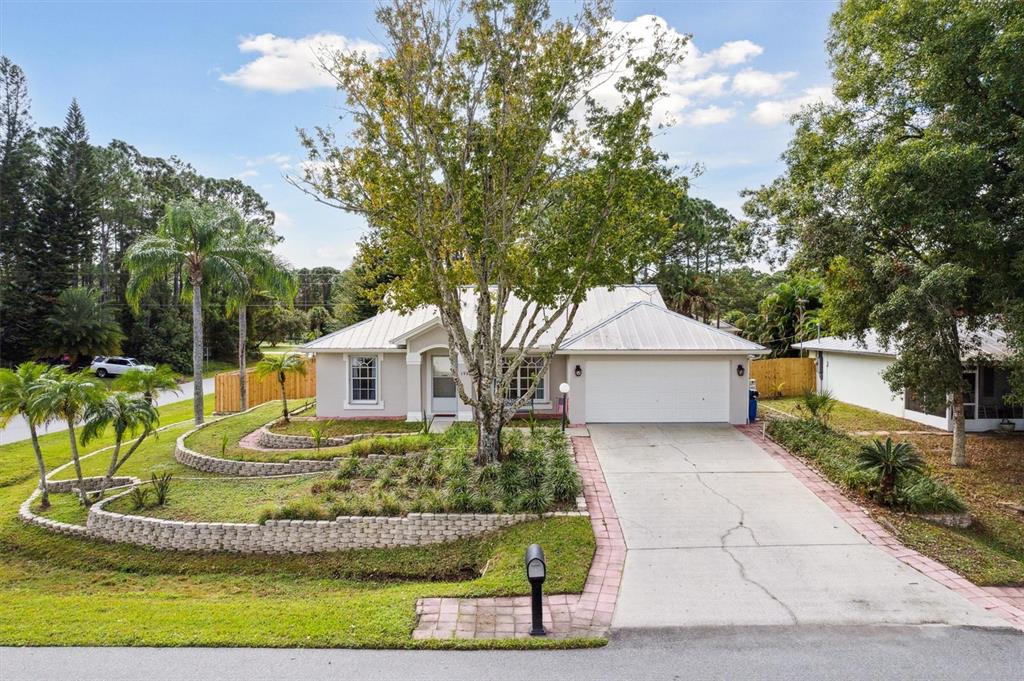 a front view of a house with a yard garage and outdoor seating