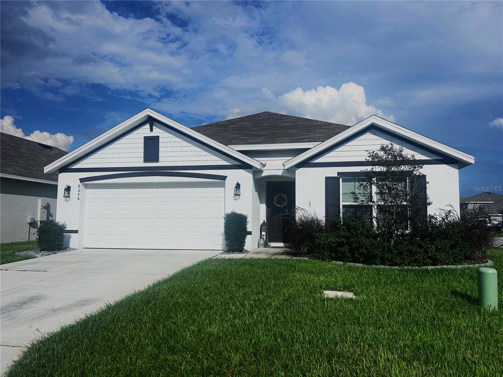 a front view of a house with a yard and garage