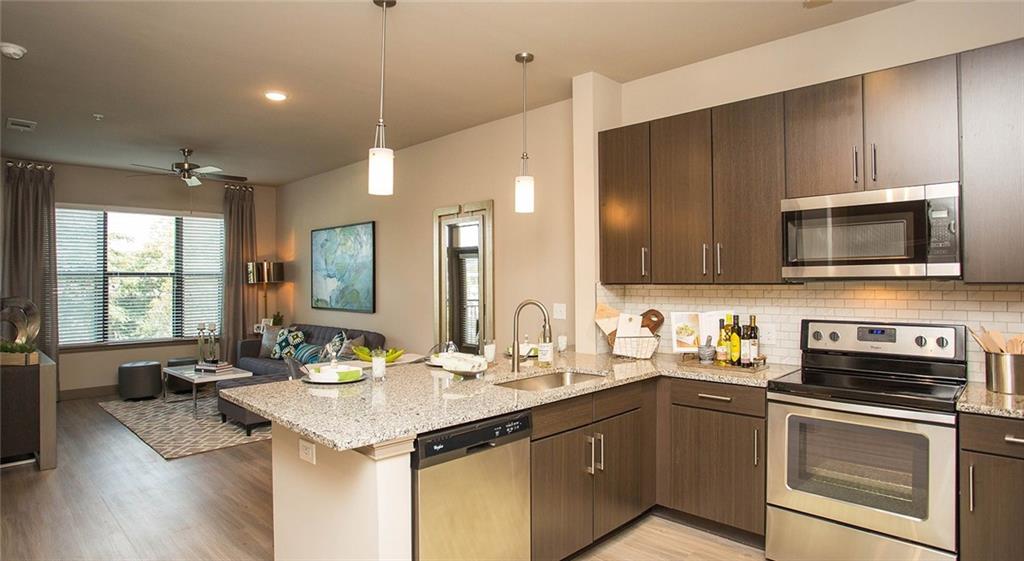 a kitchen with a sink stove and microwave