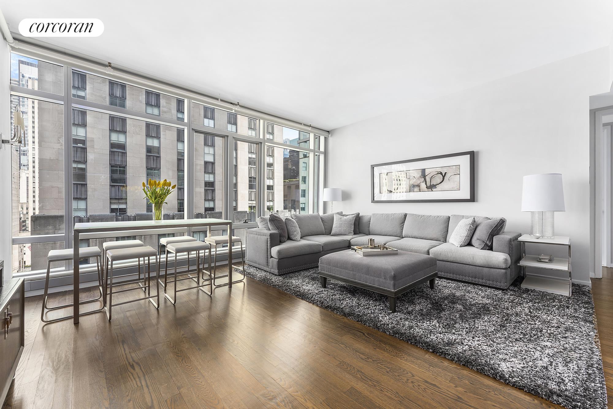 a living room with furniture and wooden floor