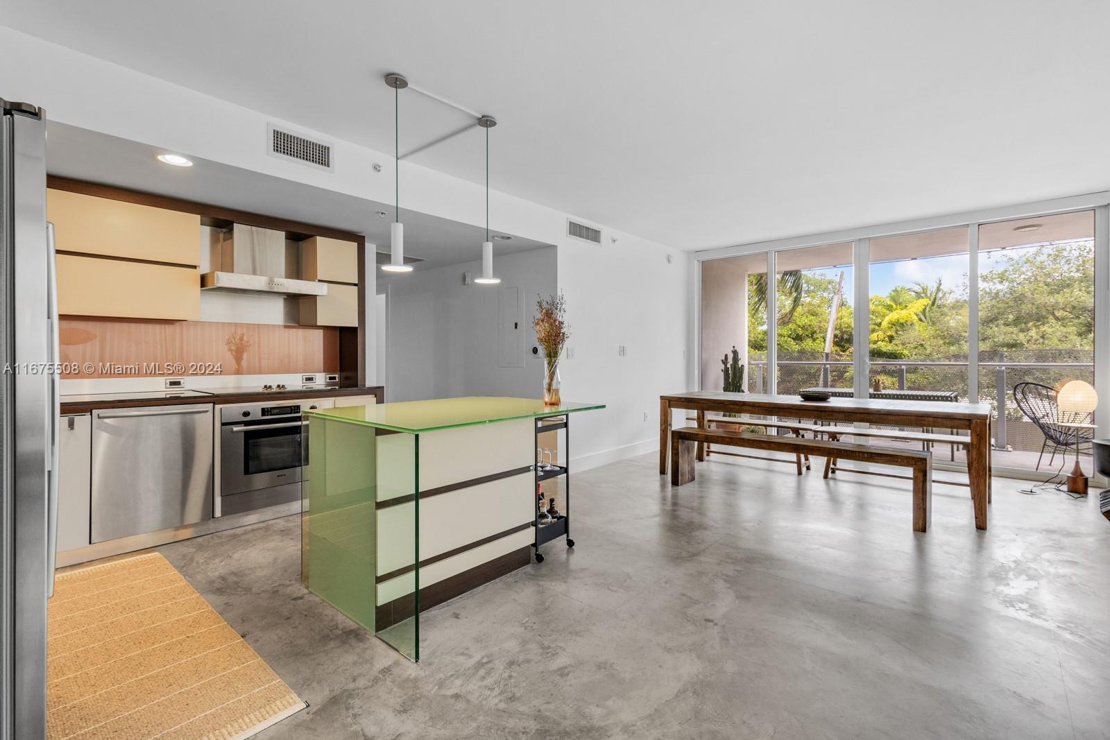 a living room with furniture a window and kitchen view