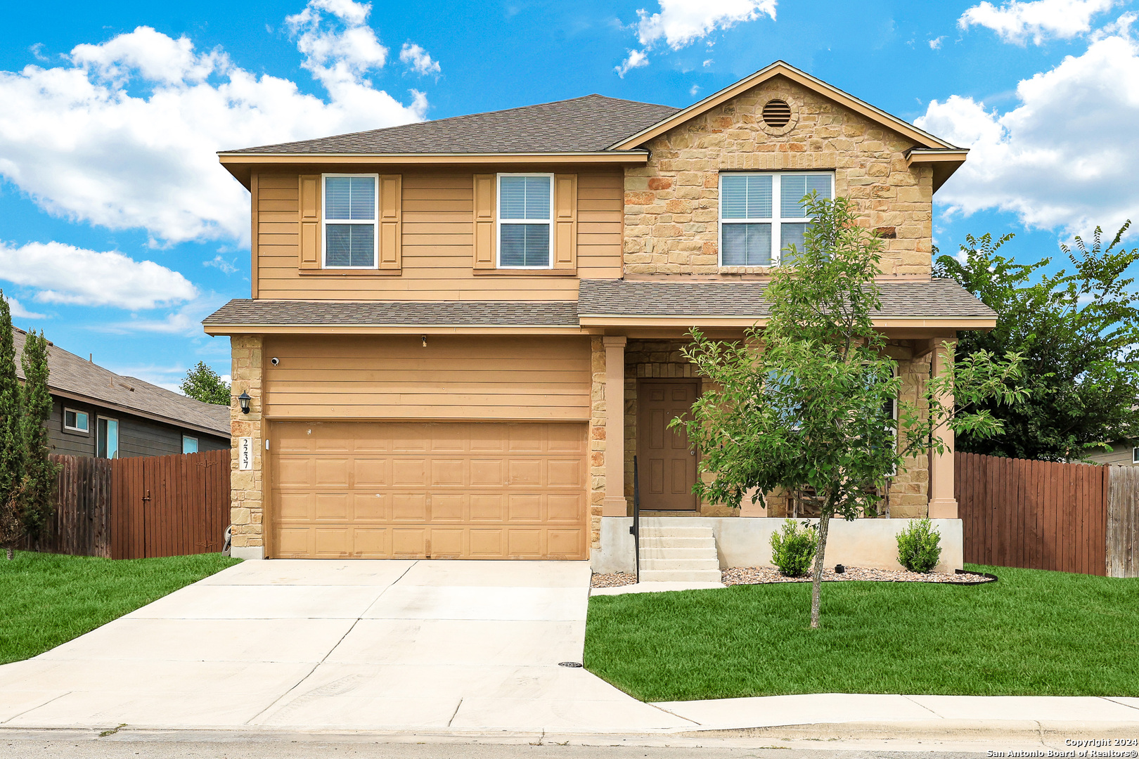 a front view of a house with a yard and garage