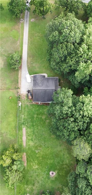 a aerial view of a house with a yard and lake view