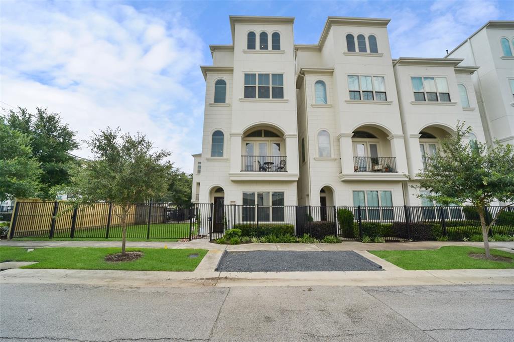 a front view of a residential apartment building with a yard