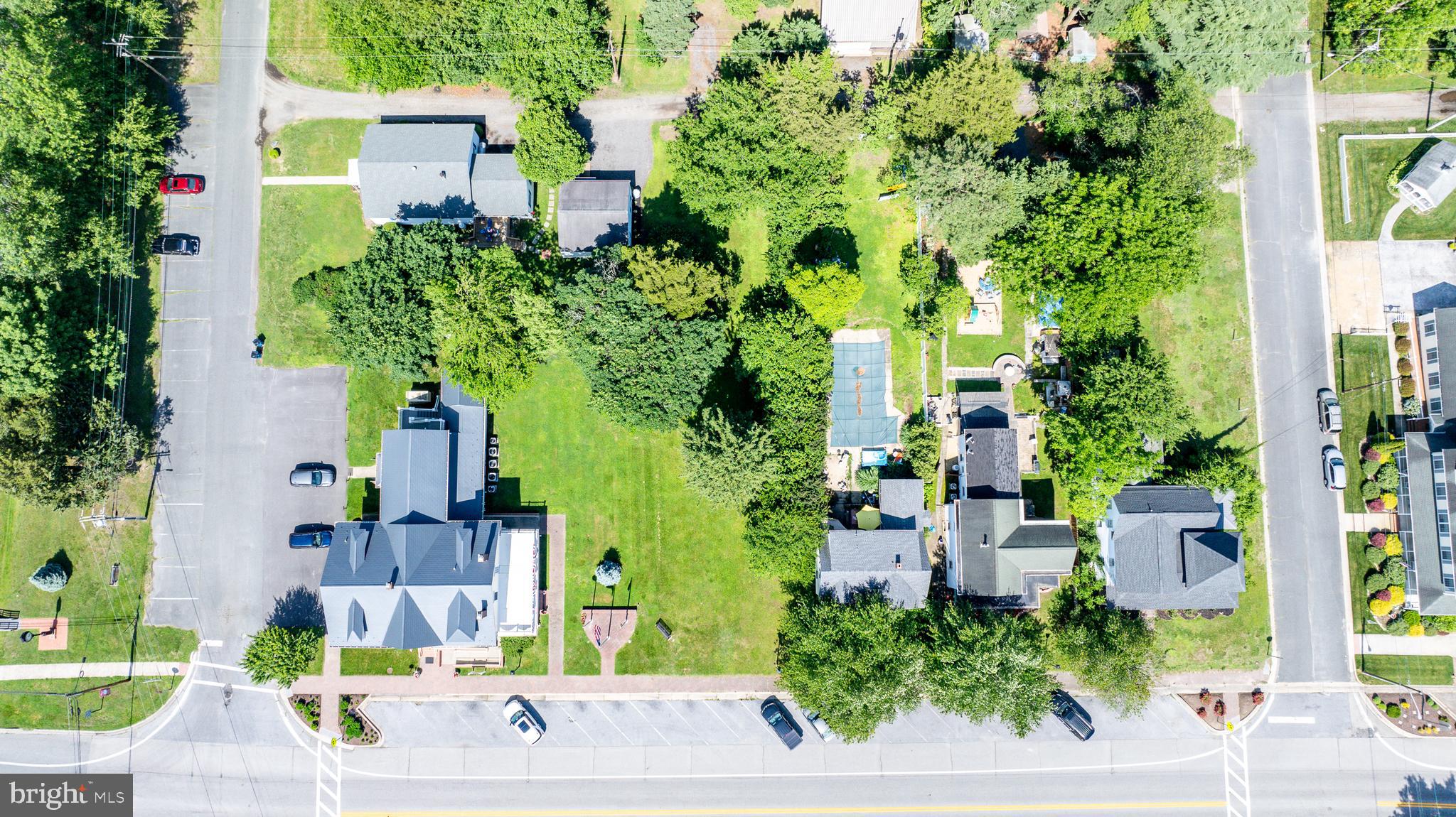 an aerial view of a house with a yard and garden