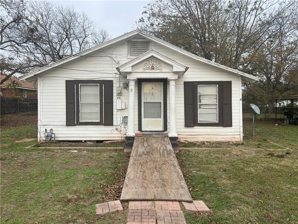 a front view of a house with yard