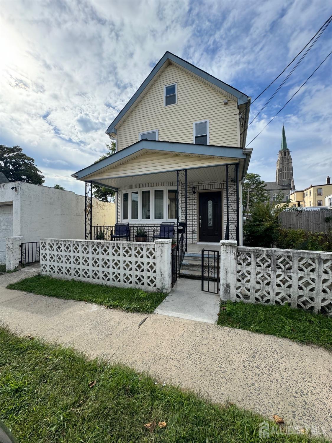 a front view of a house with a garden