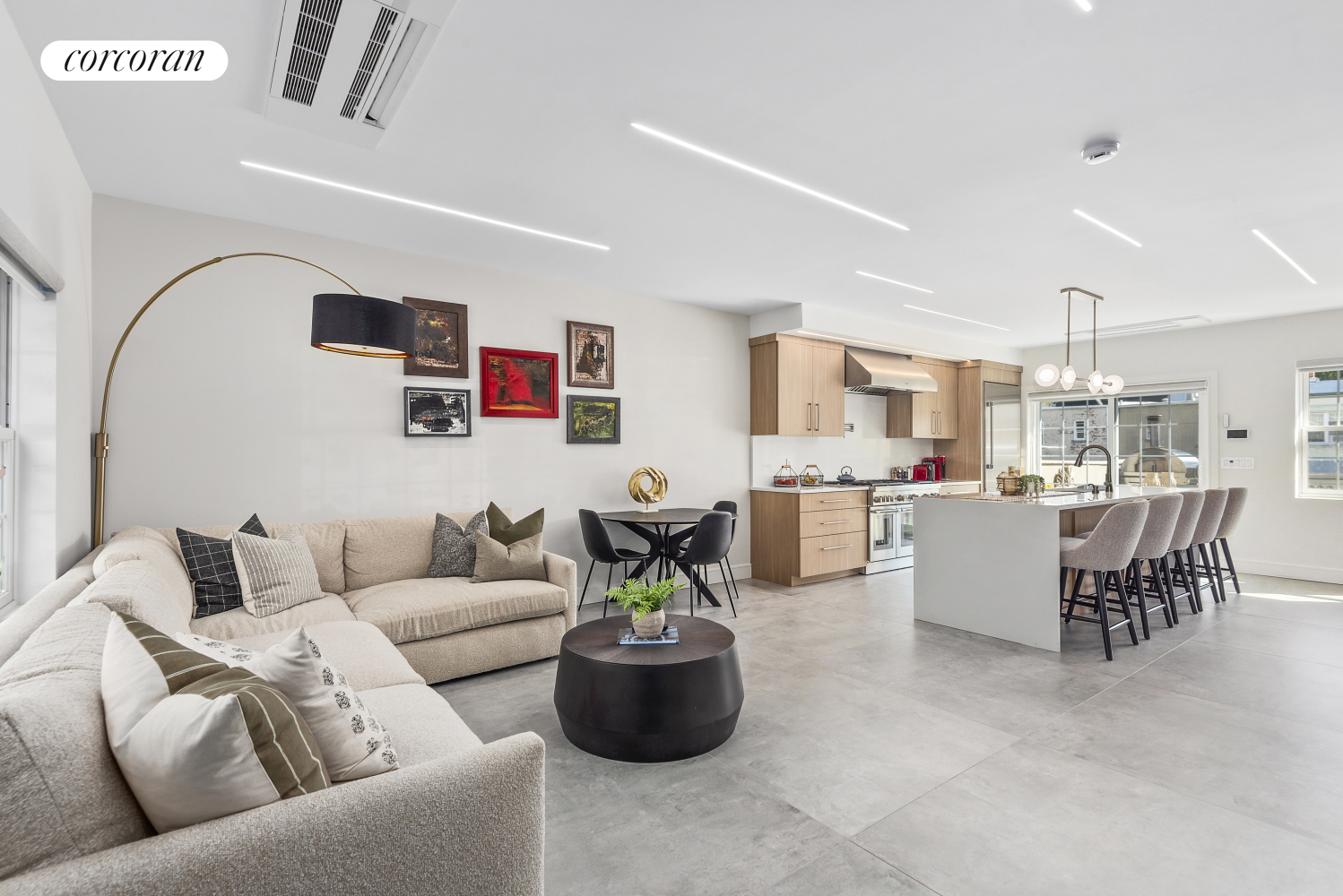 a living room with furniture and kitchen view