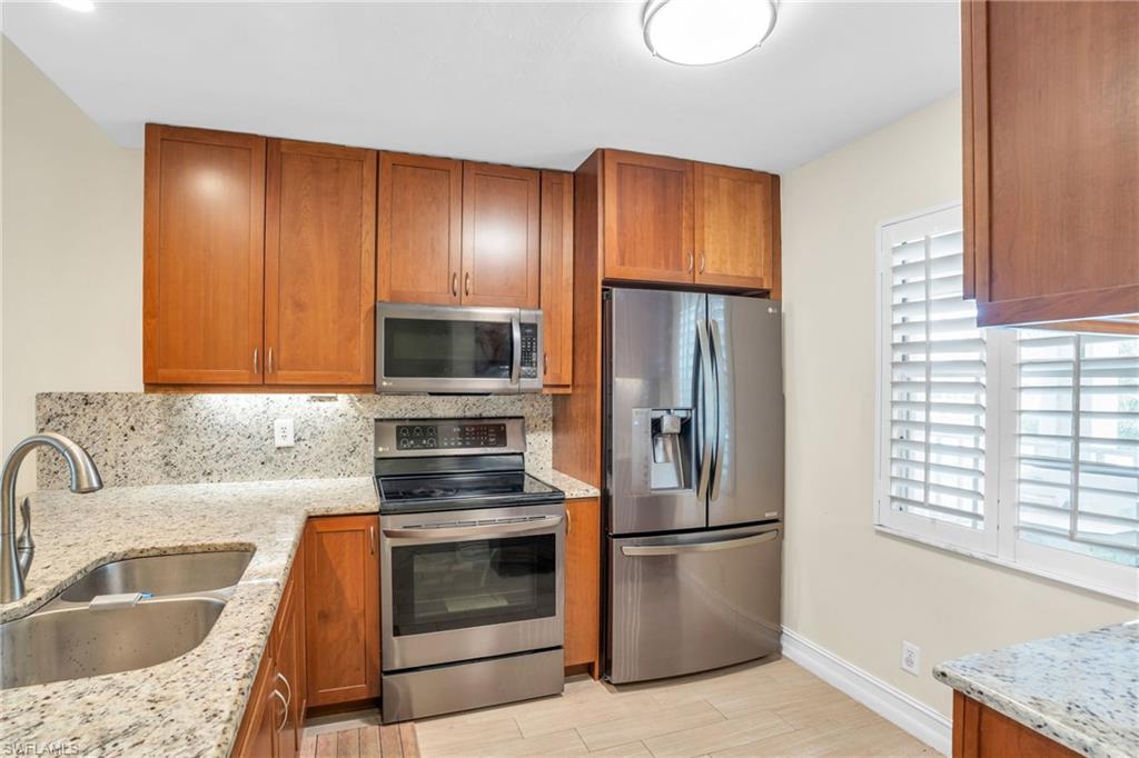 a kitchen with a refrigerator sink and microwave