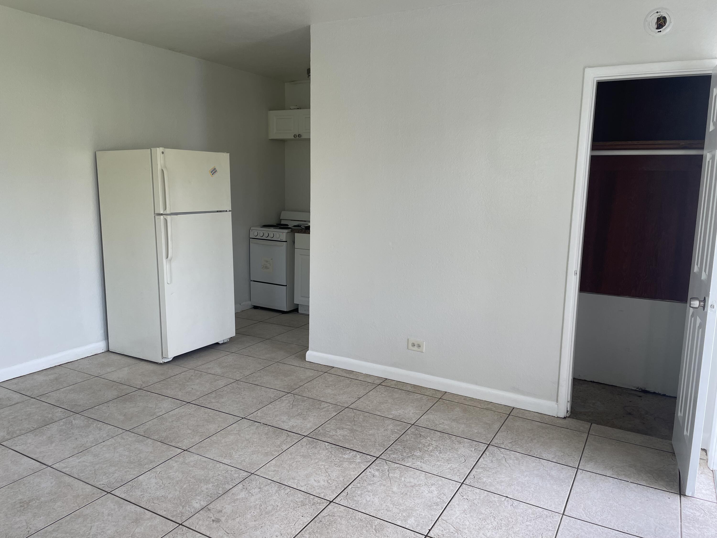 a view of cabinets and refrigerator in a kitchen