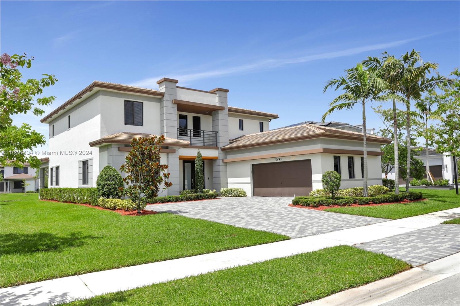 a front view of a house with a garden and plants