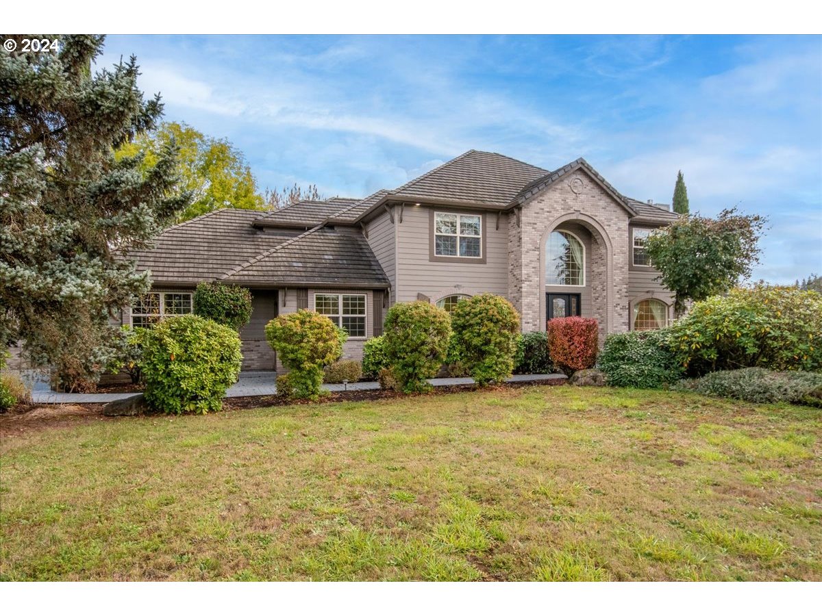 a front view of a house with a yard