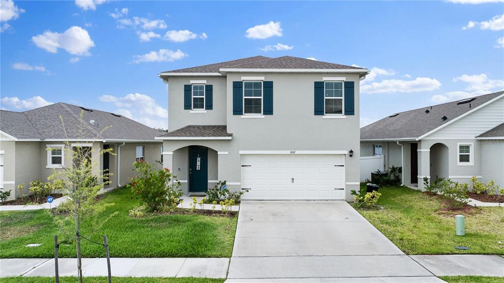 a front view of a house with a yard