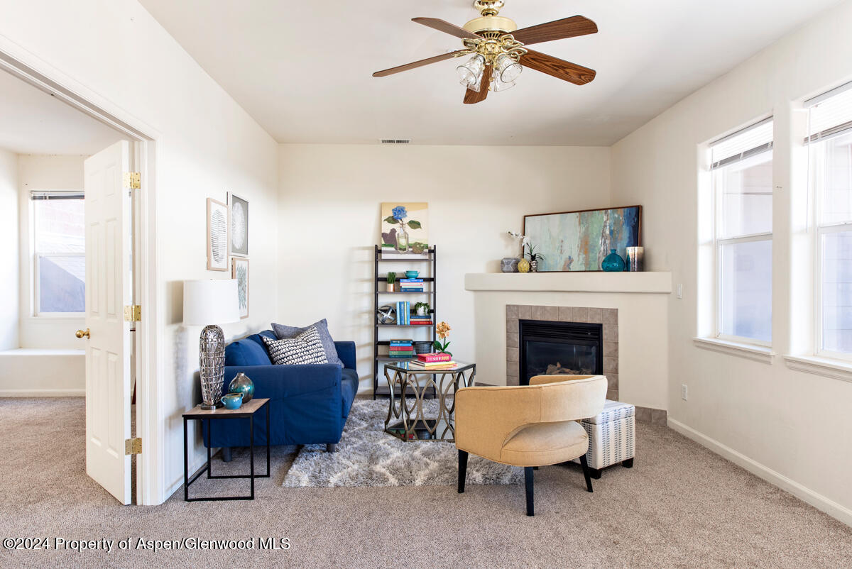 a living room with furniture and a fireplace