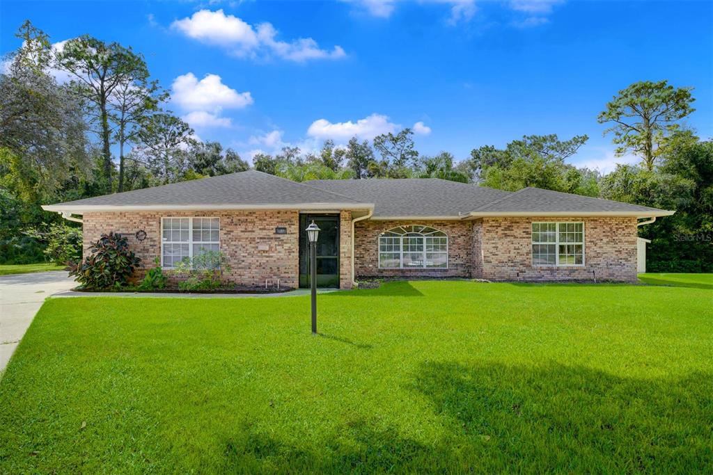 a view of a house with a yard