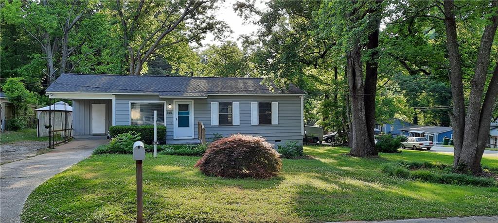 a view of house with backyard