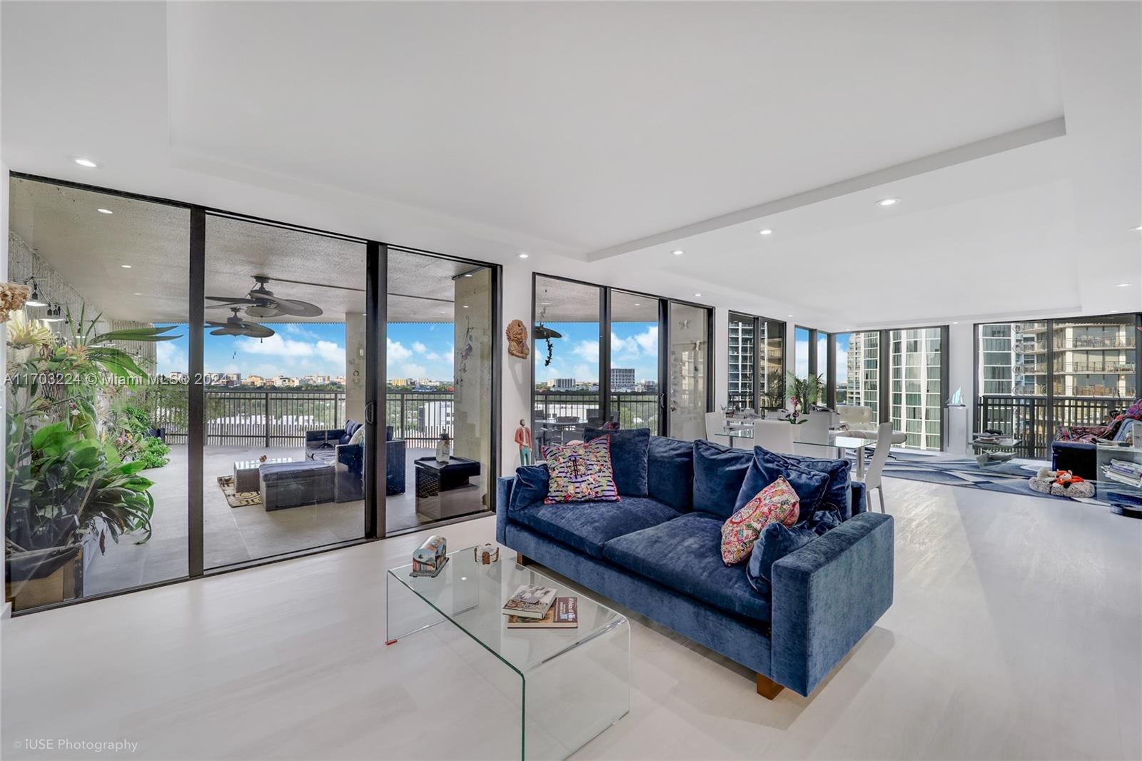 a living room with furniture and a large window with outer view