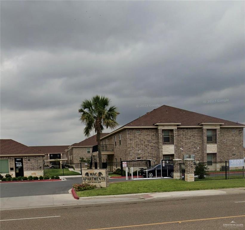 a front view of a building with parked cars