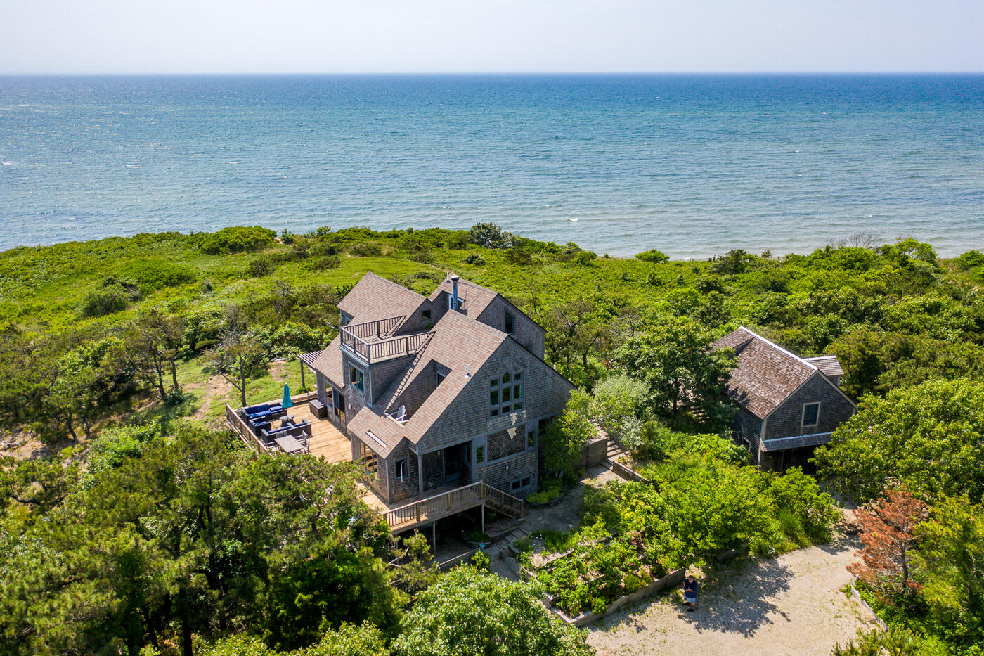 an aerial view of a house with a ocean view