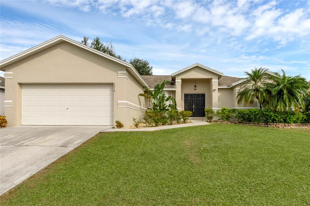 a view of a house with a yard and garage