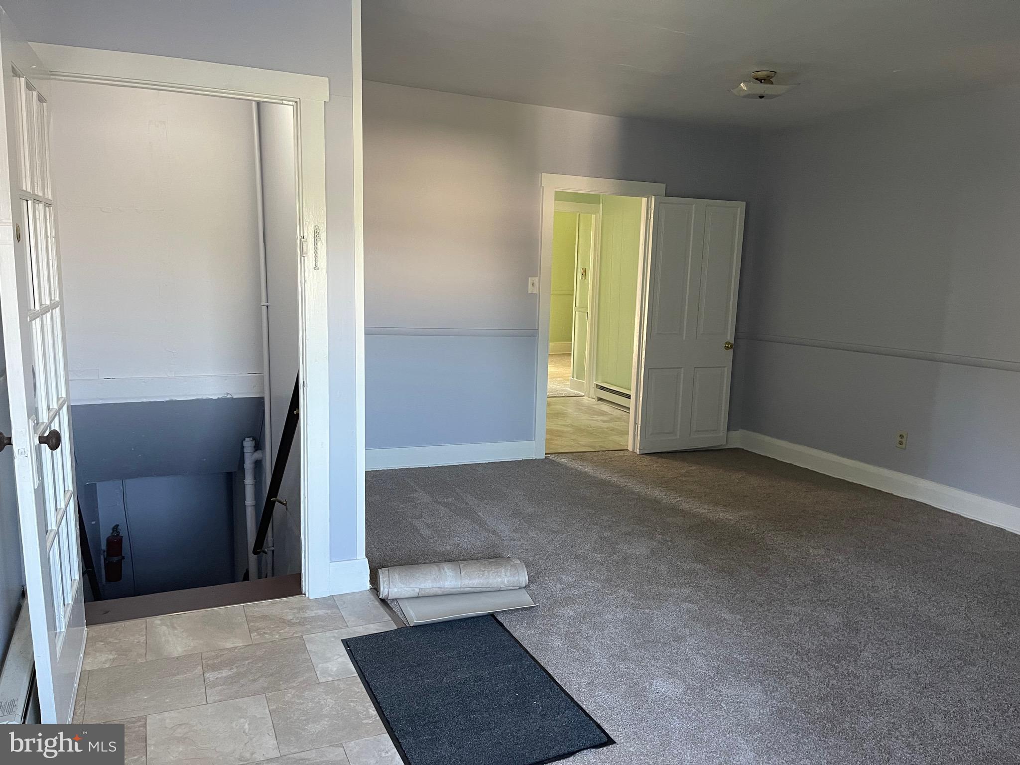 an empty room with windows and closet