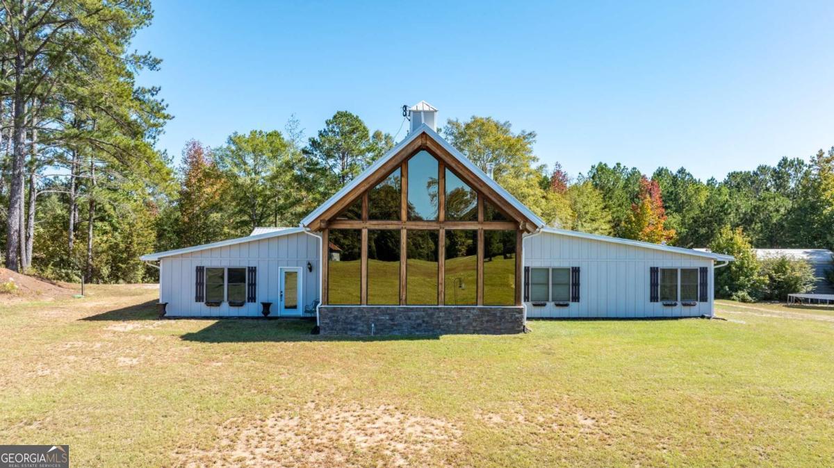 a front view of house with yard outdoor seating and barbeque oven