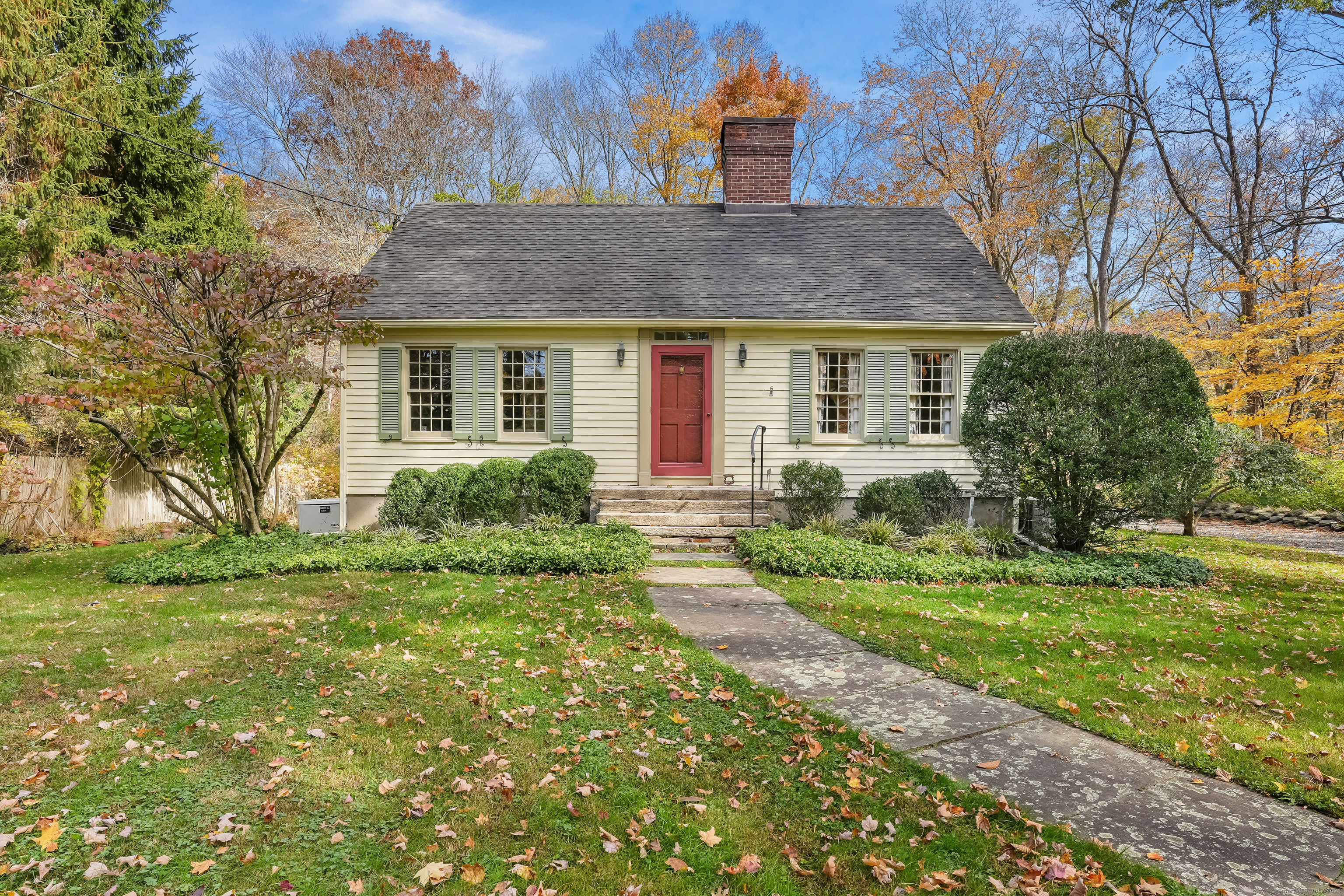 a front view of house with yard and green space