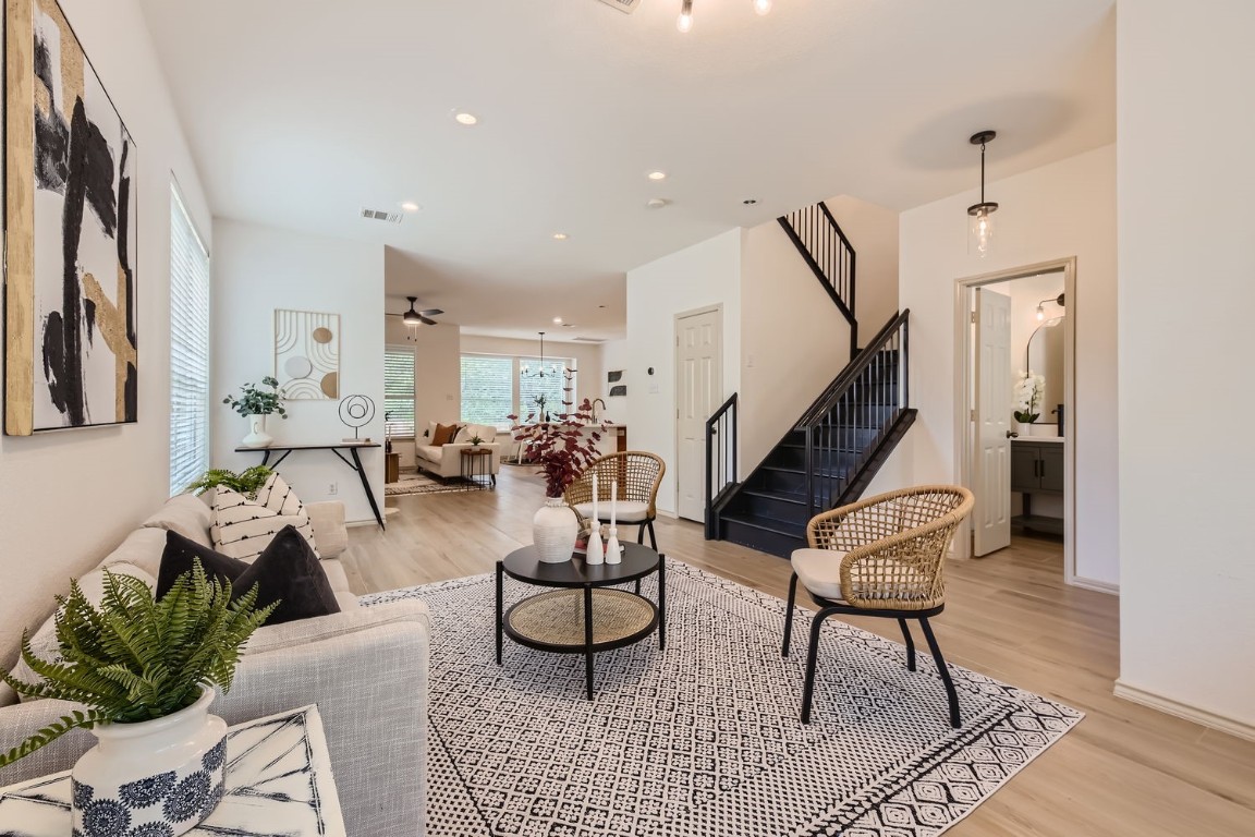 a living room with furniture and wooden floor