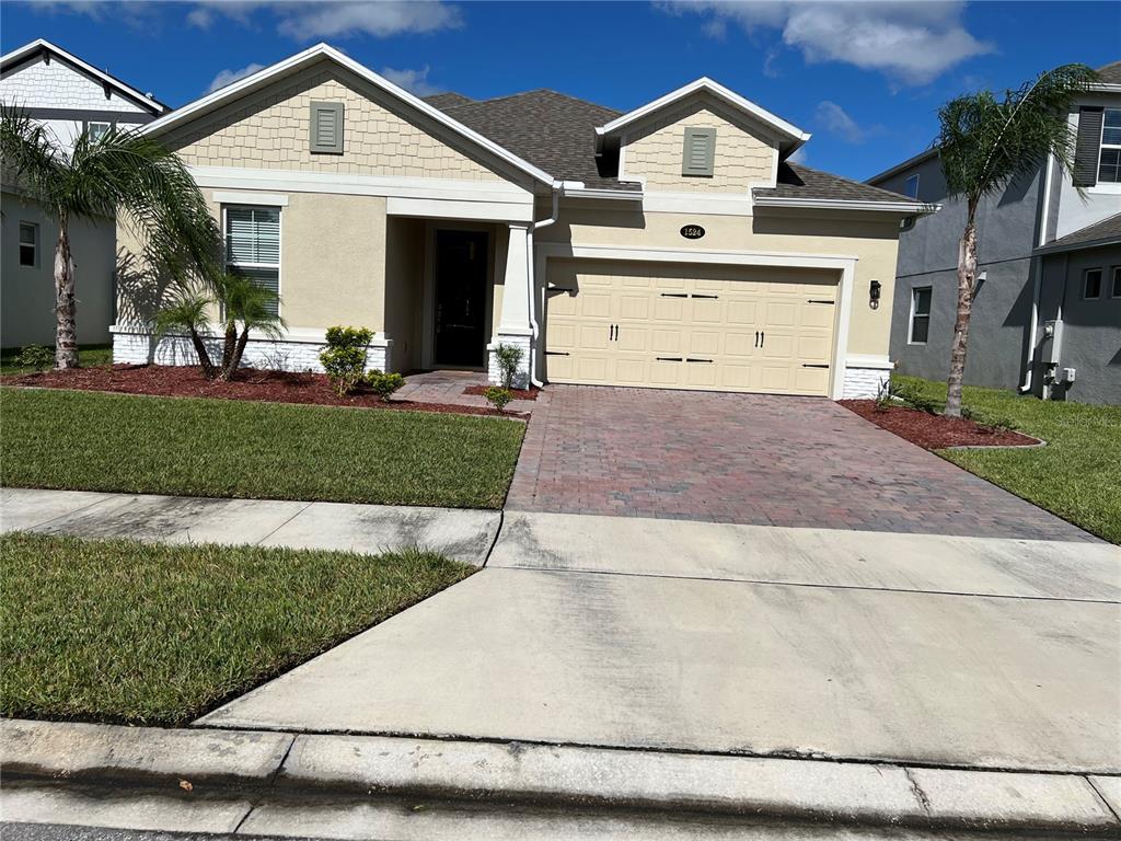 a view of a house with a yard and garage