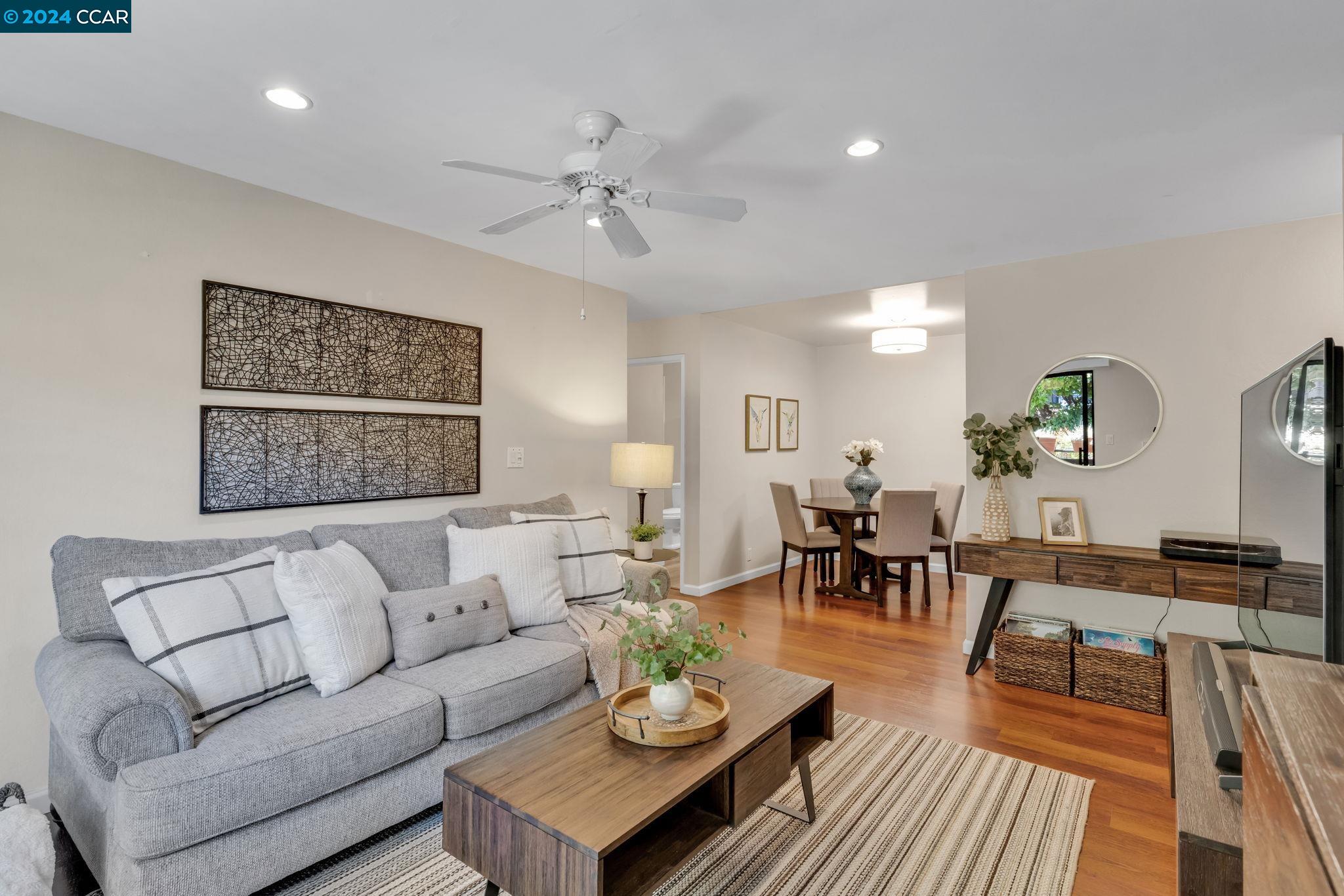 a living room with furniture kitchen view and a table