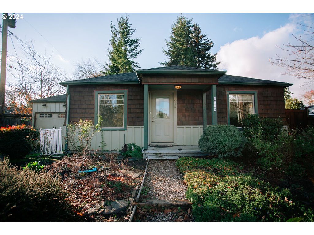 a front view of a house with garden